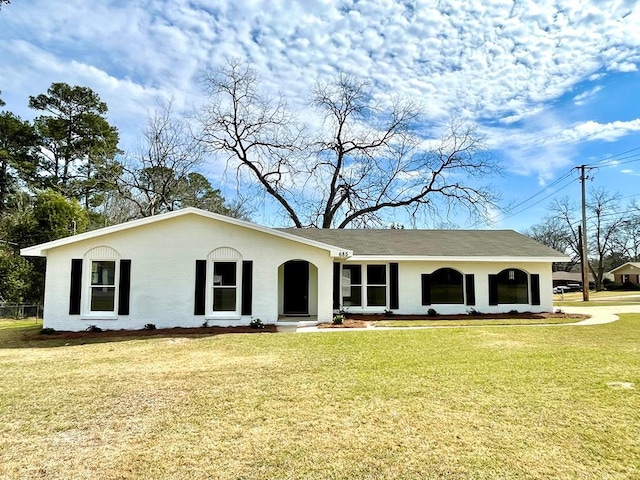 view of front facade with a front yard and stucco siding