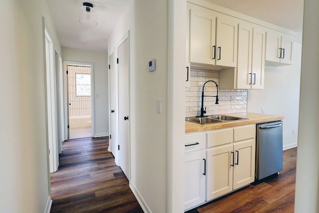 kitchen with a sink, light countertops, backsplash, dishwasher, and dark wood finished floors