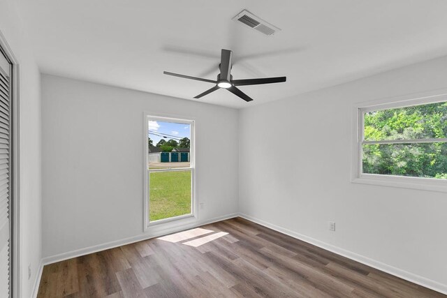 685 Hodgesville Rd, Dothan, AL 36301 - spare room with visible vents, a ceiling fan, wood finished floors, and a healthy amount of sunlight