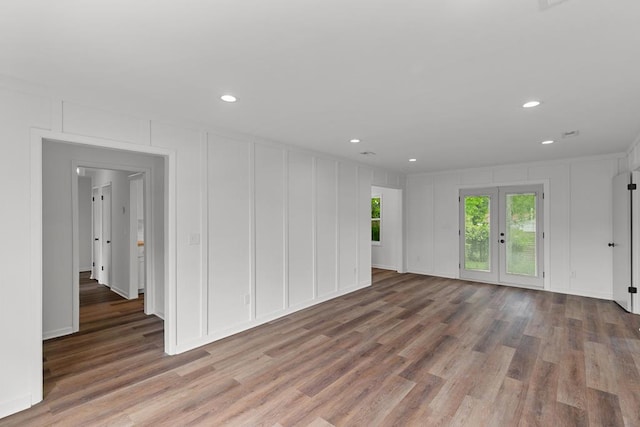 685 Hodgesville Rd, Dothan, AL 36301 - unfurnished living room featuring french doors, a decorative wall, recessed lighting, and wood finished floors
