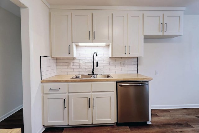 kitchen with dishwasher, baseboards, a sink, and decorative backsplash