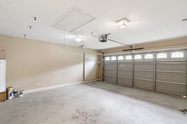 garage with a garage door opener and baseboards