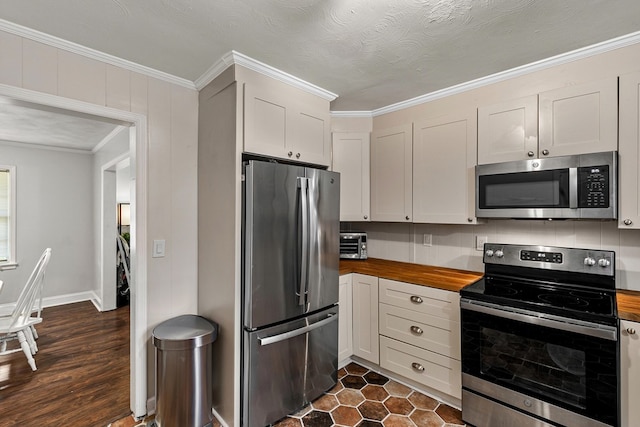 1906 Sullivan Dr, Dothan, AL 36303 - kitchen featuring stainless steel appliances, butcher block countertops, and ornamental molding