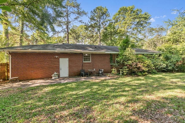 back of property with a patio area and brick siding