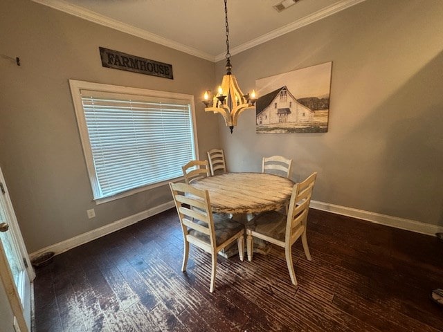 dining space featuring baseboards, a chandelier, hardwood / wood-style flooring, and crown molding