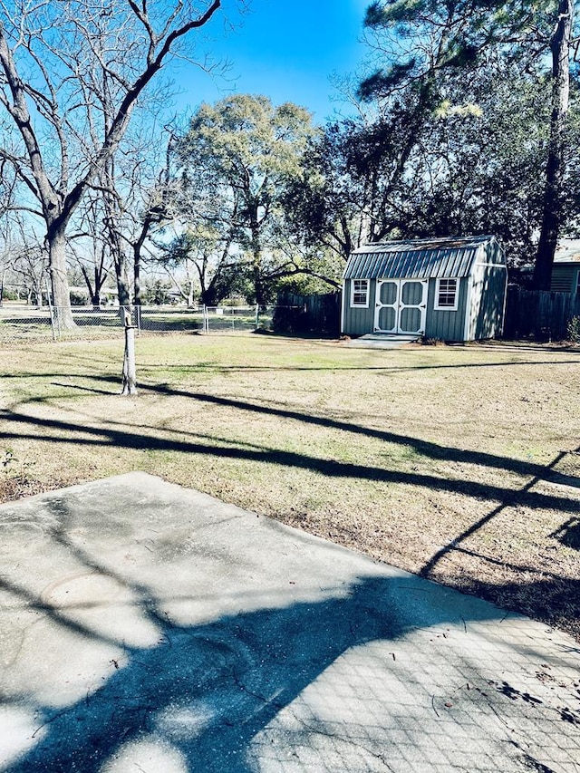 view of yard featuring a patio and a storage shed