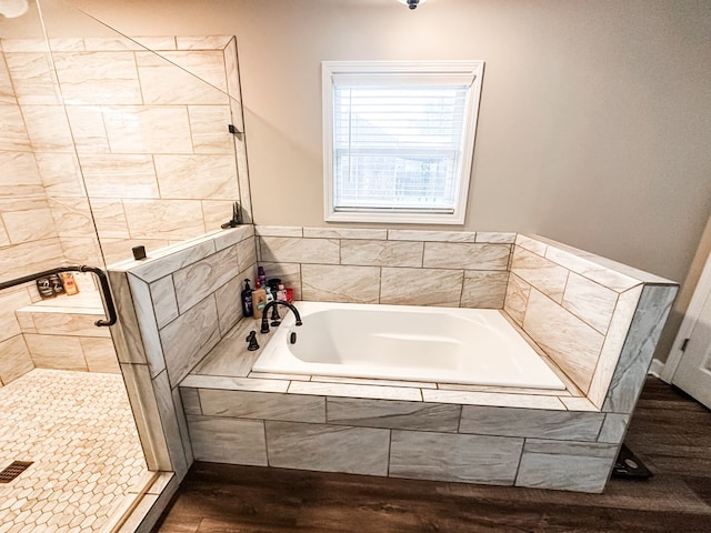 178 W Lawrence Harris Hwy, Slocomb, AL 36375 - bathroom with a garden tub, a tile shower, and wood finished floors