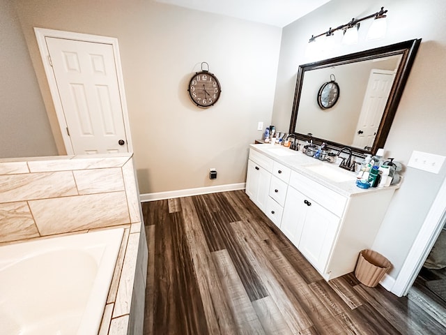 178 W Lawrence Harris Hwy, Slocomb, AL 36375 - full bathroom featuring wood finished floors, double vanity, and a garden tub