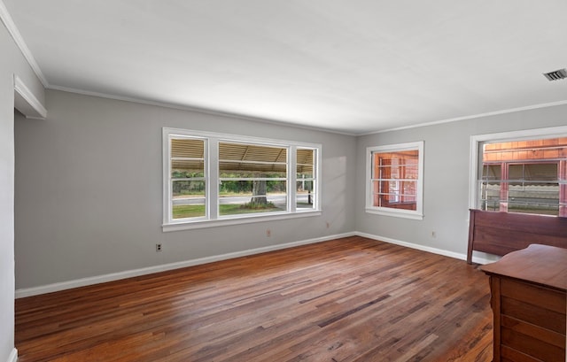 spare room with crown molding and dark hardwood / wood-style floors