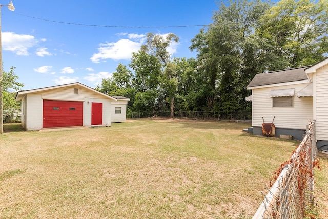 view of yard with a garage and an outdoor structure