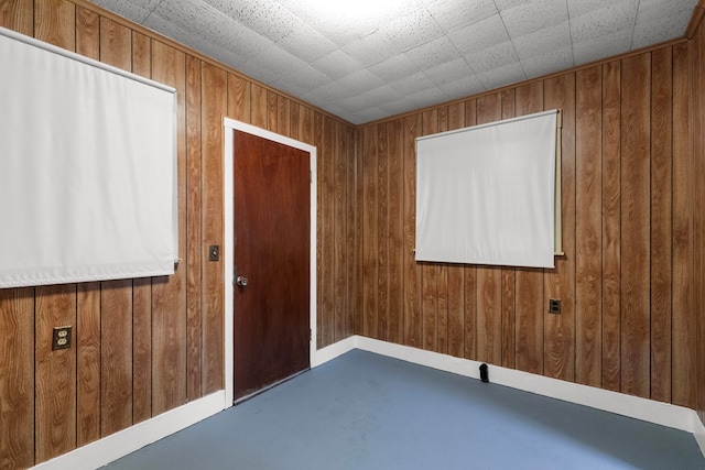 spare room with wood walls