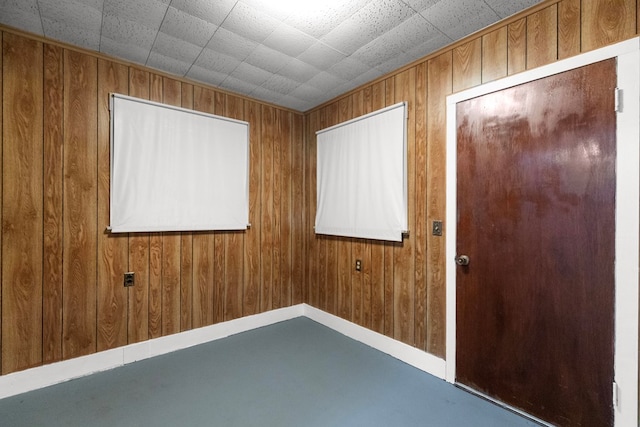 empty room featuring wooden walls