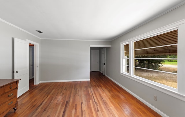 unfurnished room featuring wood-type flooring and crown molding