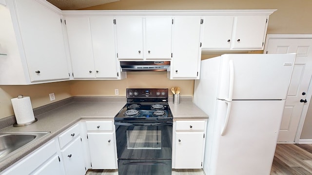 kitchen featuring white cabinets, white fridge, exhaust hood, and black / electric stove