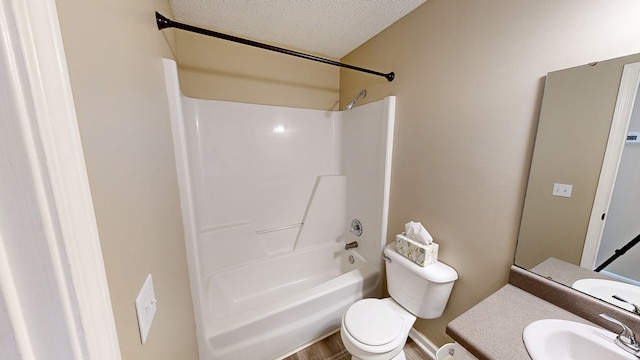 full bathroom featuring shower / bath combination, vanity, a textured ceiling, wood-type flooring, and toilet