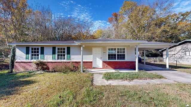 ranch-style home featuring a front yard and a carport