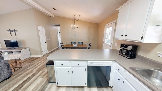 kitchen with dishwasher, lofted ceiling with beams, white cabinetry, and decorative light fixtures