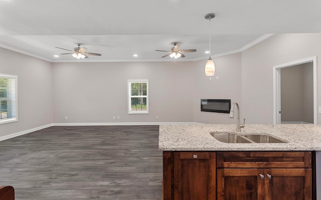 kitchen featuring ceiling fan, sink, dark wood-type flooring, light stone counters, and pendant lighting