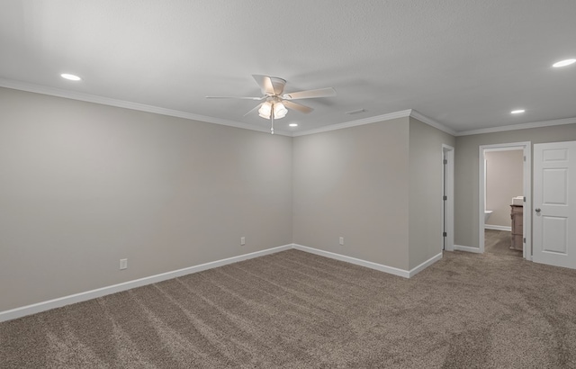 carpeted spare room featuring ceiling fan and crown molding