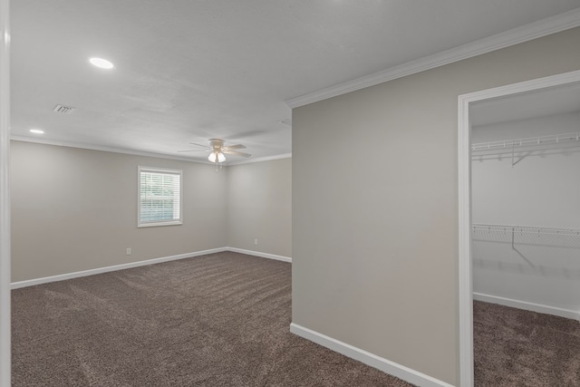 unfurnished bedroom featuring ceiling fan, a closet, dark carpet, and ornamental molding