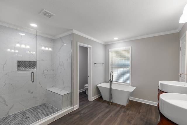 bathroom with hardwood / wood-style floors, toilet, double sink, and crown molding