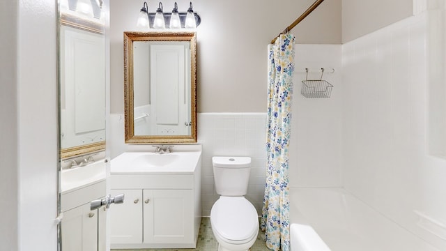 full bathroom featuring vanity, toilet, tile walls, and shower / tub combo