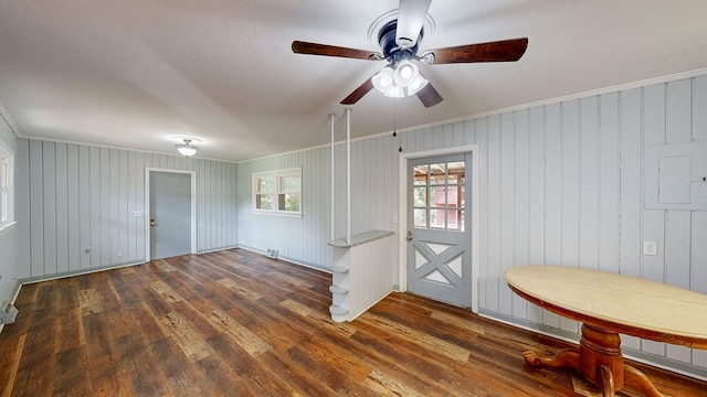 entrance foyer featuring dark hardwood / wood-style flooring, crown molding, and wood walls