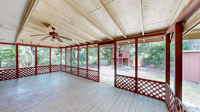 unfurnished sunroom with ceiling fan and lofted ceiling