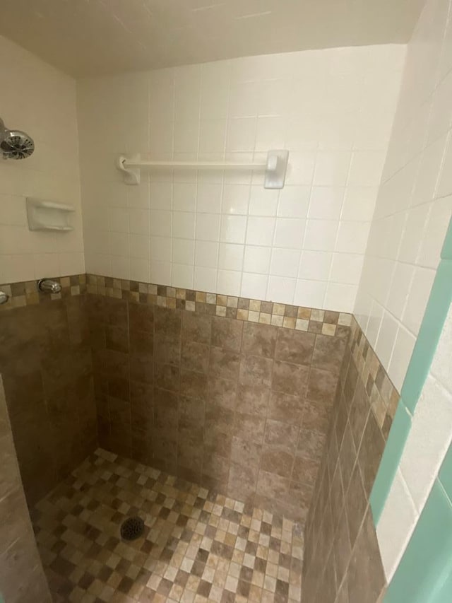 bathroom with tiled shower