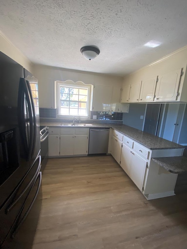 kitchen featuring white cabinetry, stainless steel dishwasher, kitchen peninsula, light hardwood / wood-style floors, and black fridge with ice dispenser