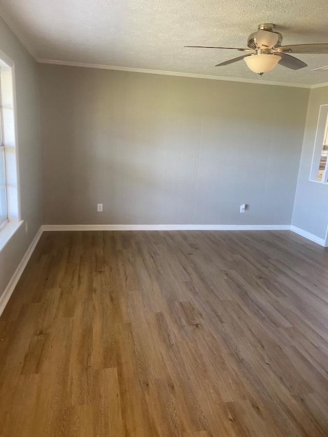 spare room with a textured ceiling, hardwood / wood-style flooring, ceiling fan, and ornamental molding