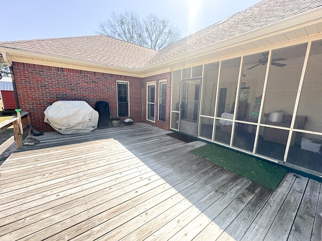 wooden terrace with area for grilling and a sunroom