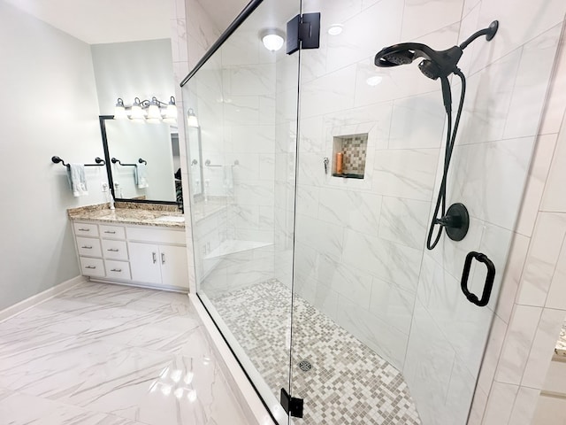 bathroom featuring baseboards, vanity, marble finish floor, and a shower stall