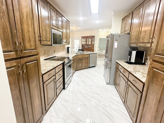 kitchen featuring decorative backsplash, marble finish floor, stainless steel appliances, and a sink