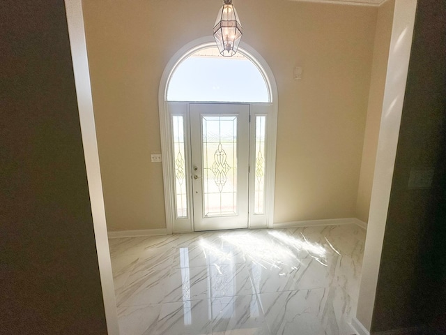 entryway with marble finish floor and baseboards