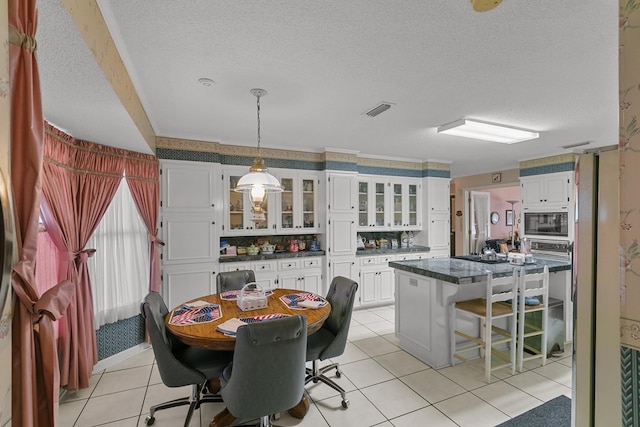 1764 John D Odom Rd, Dothan, AL 36303 - dining area featuring a textured ceiling and light tile patterned floors