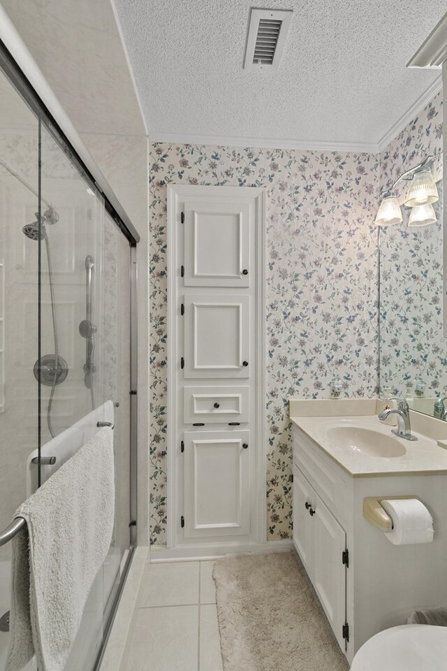 1764 John D Odom Rd, Dothan, AL 36303 - bathroom with wallpapered walls, a textured ceiling, vanity, a stall shower, and tile patterned floors