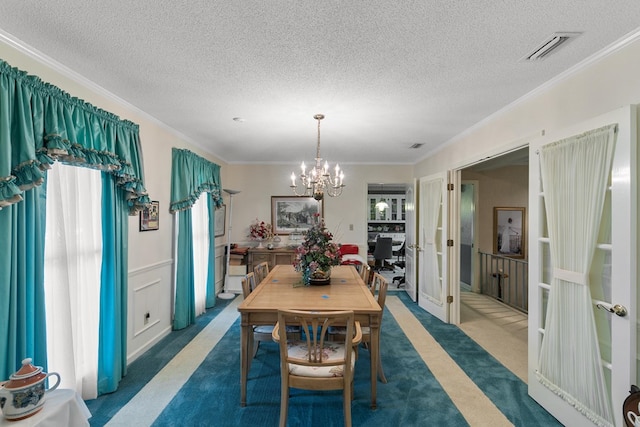 1764 John D Odom Rd, Dothan, AL 36303 - carpeted dining room with a chandelier, crown molding, and a textured ceiling