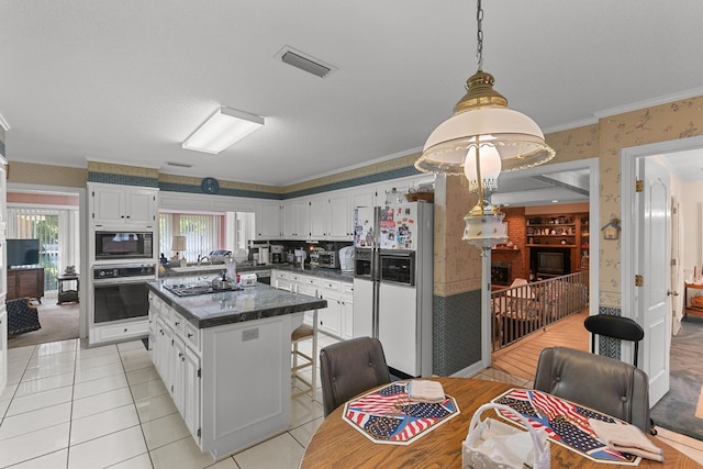 1764 John D Odom Rd, Dothan, AL 36303 - kitchen featuring white appliances, wallpapered walls, a center island, white cabinetry, and crown molding
