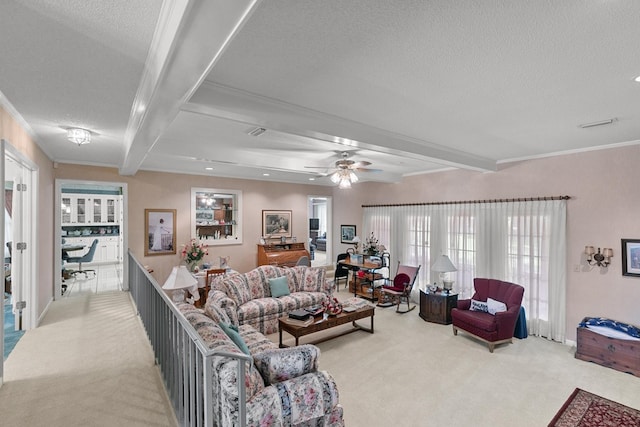 1764 John D Odom Rd, Dothan, AL 36303 - carpeted living area featuring beamed ceiling, a textured ceiling, a ceiling fan, ornamental molding, and healthy amount of natural light