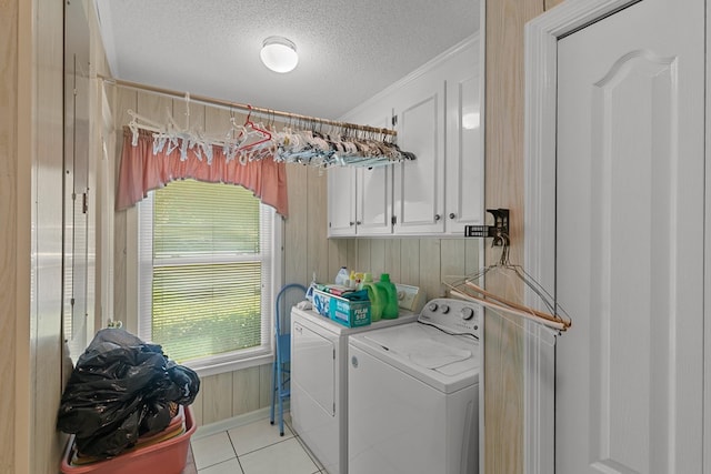 1764 John D Odom Rd, Dothan, AL 36303 - laundry room with independent washer and dryer, cabinet space, a textured ceiling, light tile patterned flooring, and wooden walls
