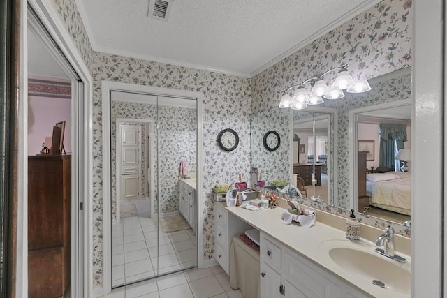 1764 John D Odom Rd, Dothan, AL 36303 - ensuite bathroom with wallpapered walls, crown molding, vanity, tile patterned floors, and a textured ceiling