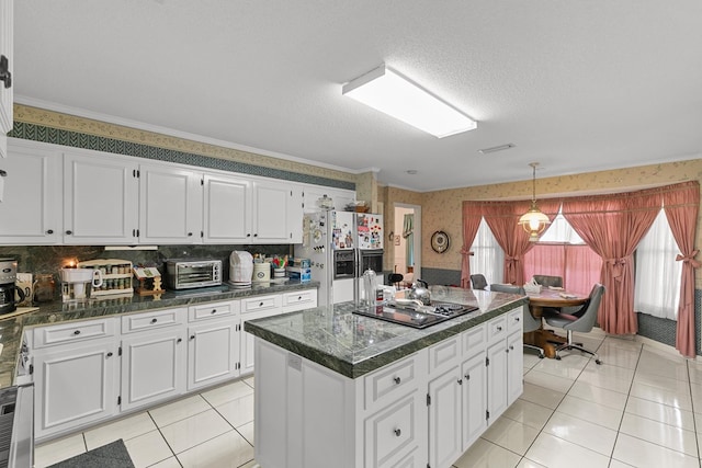1764 John D Odom Rd, Dothan, AL 36303 - kitchen with wallpapered walls, fridge with ice dispenser, black electric stovetop, dark countertops, and white cabinetry