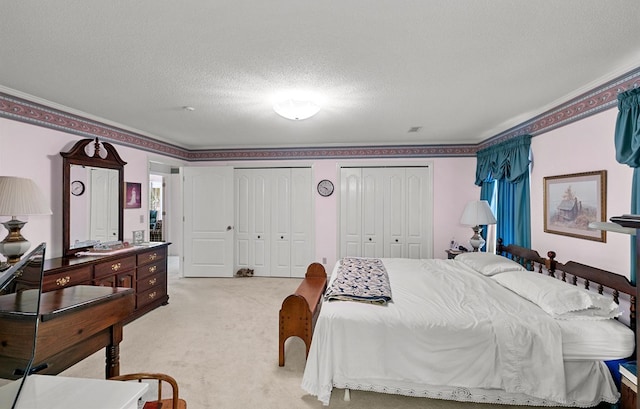 1764 John D Odom Rd, Dothan, AL 36303 - bedroom with multiple closets, light colored carpet, and a textured ceiling