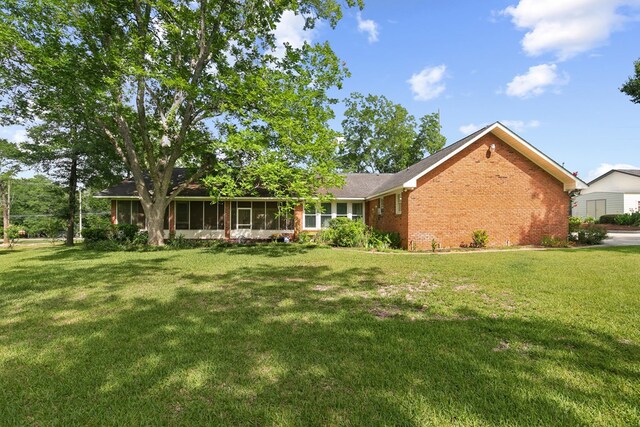 1764 John D Odom Rd, Dothan, AL 36303 - back of property with brick siding, a sunroom, and a yard