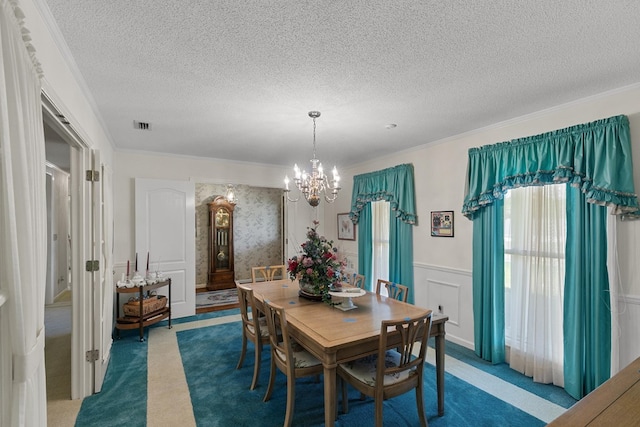 1764 John D Odom Rd, Dothan, AL 36303 - dining space with a chandelier, carpet floors, wainscoting, a textured ceiling, and ornamental molding