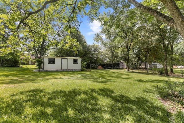 1764 John D Odom Rd, Dothan, AL 36303 - view of grassy yard with a storage unit and view of wooded area