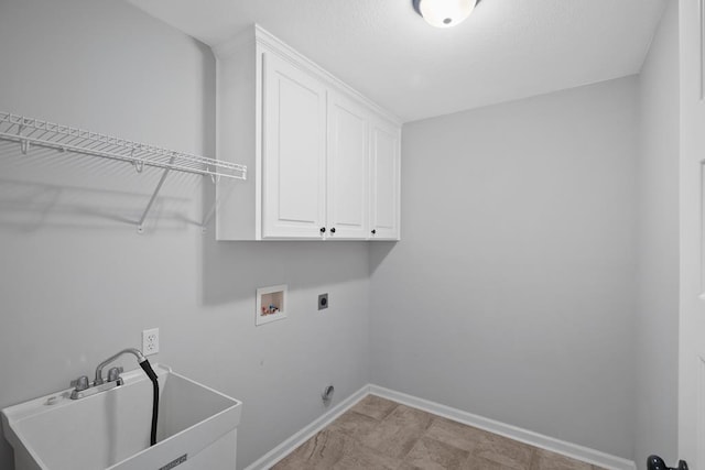 laundry room featuring washer hookup, a sink, baseboards, cabinet space, and electric dryer hookup