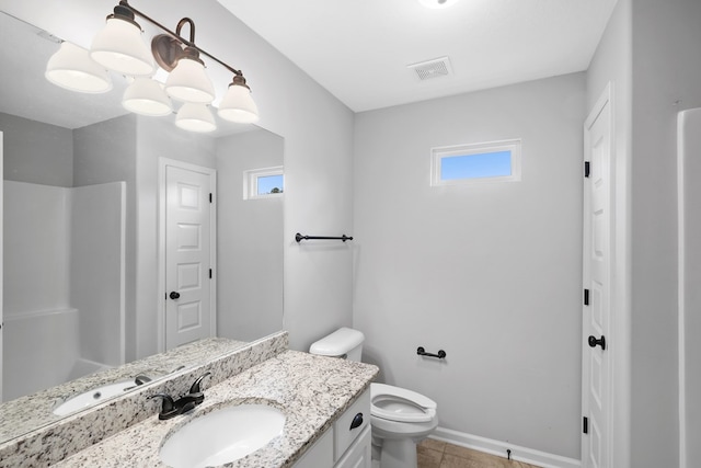 bathroom featuring toilet, vanity, visible vents, baseboards, and walk in shower