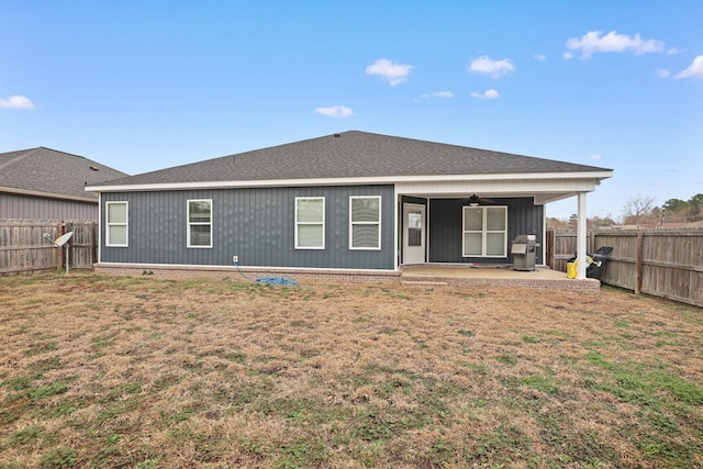 back of house featuring ceiling fan, a lawn, a patio area, and a fenced backyard